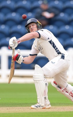 300826 Glamorgan v Hampshire, Rothesay County Championship Division 1 - Ben Brown of Hampshire plays a shot as Chris Cooke of Glamorgan looks on