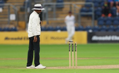 300826 Glamorgan v Hampshire, Rothesay County Championship Division 1 - Umpire Suri Shanmugam checks the light levels before stopping play, firstly for bad light and almost immediately rain