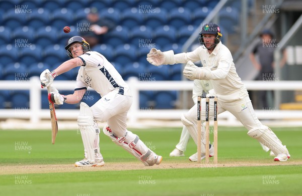 300826 Glamorgan v Hampshire, Rothesay County Championship Division 1 - Ben Brown of Hampshire plays a shot as Chris Cooke of Glamorgan looks on