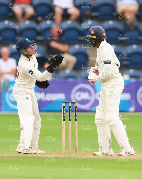 240725  Glamorgan v Kent, Rothesay County Championship Division 2, Day 3 - Alex Horton of Glamorgan takes the ball as Daniel Bell-Drummond of Kent looks on