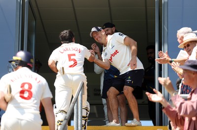 250725 - Glamorgan v Kent - Rothesay County Championship Division 2 - Kiran Carlson of Glamorgan celebrates at the end of the match with Colin Ingram