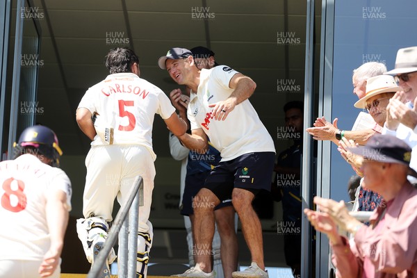 250725 - Glamorgan v Kent - Rothesay County Championship Division 2 - Kiran Carlson of Glamorgan celebrates at the end of the match with Colin Ingram