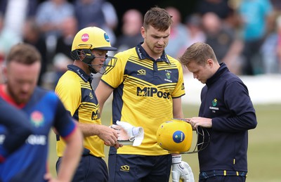 170822 - Glamorgan v Lancashire, Royal London One Day Cup - Joe Cooke of Glamorgan’s helmet is examined after it is struck by the ball as he looked to play a shot