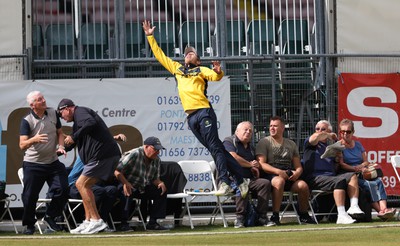 170822 - Glamorgan v Lancashire, Royal London One Day Cup - Tom Cullen of Glamorgan crashes into spectators as he attempts to catch a ball heading for a six