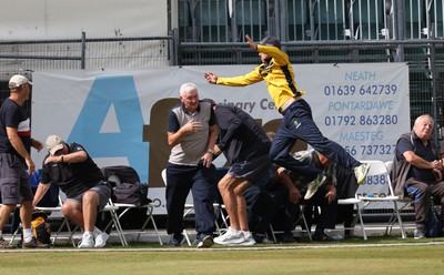 170822 - Glamorgan v Lancashire, Royal London One Day Cup - Tom Cullen of Glamorgan crashes into spectators as he attempts to catch a ball heading for a six