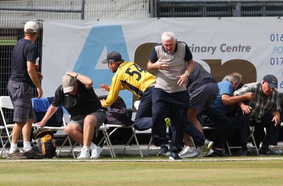 170822 - Glamorgan v Lancashire, Royal London One Day Cup - Tom Cullen of Glamorgan crashes into spectators as he attempts to catch a ball heading for a six