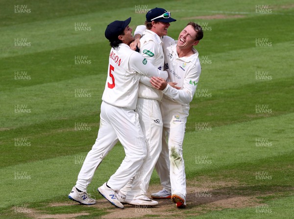 050522 - Glamorgan v Leicestershire - LV= County Championship - Division Two - Sam Northeast of Glamorgan celebrates taking the wicket of Hassan Azad with team mates Kiran Carlson and Marnus Labuschagne