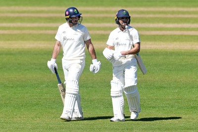 240426 - Glamorgan v Leicestershire - Rothesay County Championship - Colin Ingram of Glamorgan walks onto the pitch with Kiran Carlson for his 150th appearance 