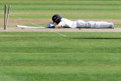 240426 - Glamorgan v Leicestershire - Rothesay County Championship - Kiran Carlson of Glamorgan is run out by Jake Weatherald of Leicestershire