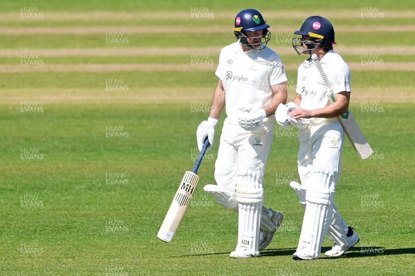 240426 - Glamorgan v Leicestershire - Rothesay County Championship - Colin Ingram of Glamorgan walks onto the pitch with Kiran Carlson for his 150th appearance 