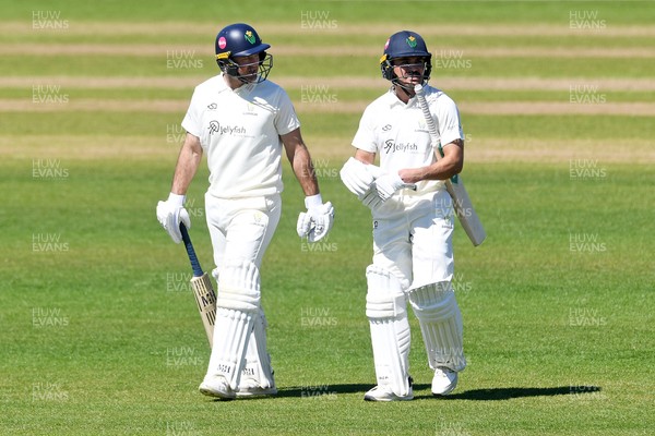 240426 - Glamorgan v Leicestershire - Rothesay County Championship - Colin Ingram of Glamorgan walks onto the pitch with Kiran Carlson for his 150th appearance 