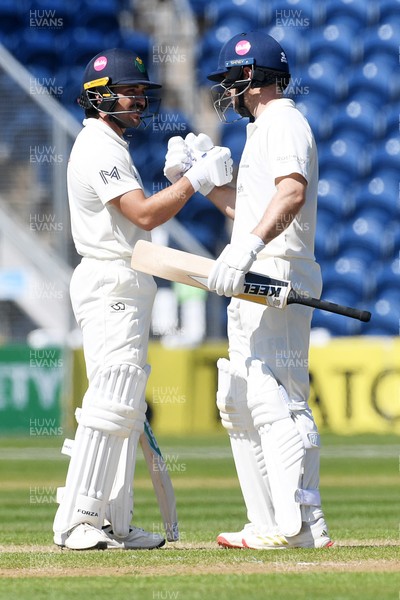 240426 - Glamorgan v Leicestershire - Rothesay County Championship - Kiran Carlson of Glamorgan is congratulated by Sean Dickson after hitting 50