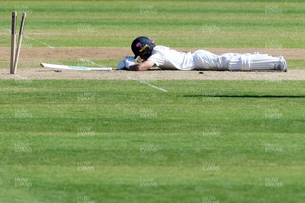 240426 - Glamorgan v Leicestershire - Rothesay County Championship - Kiran Carlson of Glamorgan is run out by Jake Weatherald of Leicestershire