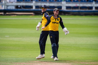 260825 - Glamorgan v Leicestershire - Metro Bank One Day Cup - Henry Hurle of Glamorgan CCC and Will Smale of Glamorgan CCC celebrate the wicket of Peter Hanscombe of Leicestershire CCC