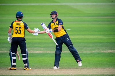 260825 - Glamorgan v Leicestershire - Metro Bank One Day Cup - Will Smale of Glamorgan CCC celebrates his fifty with Asa Tribe of Glamorgan CCC