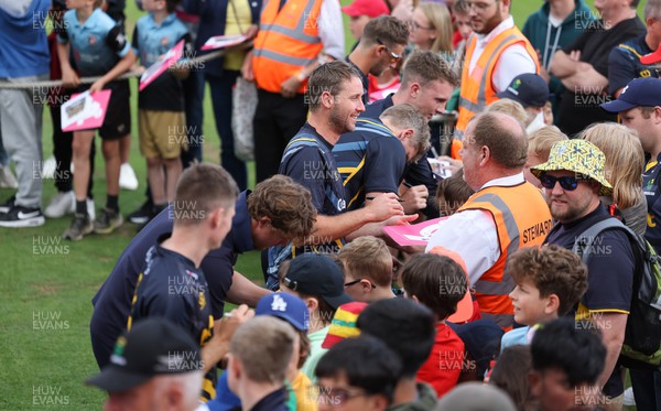 020723 - Glamorgan v Middlesex, Vitality Blast - Glamorgan players sign autographs for supporters at the end of the match