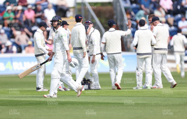 210422 - Glamorgan v Middlesex, LV= County Championship Division 2  - James Harris of Glamorgan makes his back to the pavilion as Middlesex celebrate taking his wicket