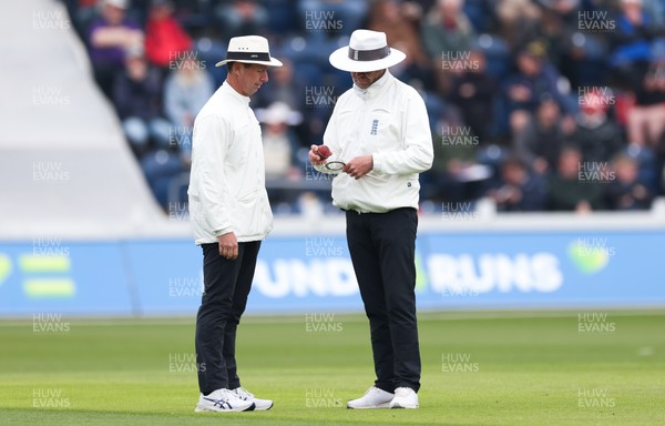 220422 - Glamorgan v Middlesex, LV= County Championship Division 2  - The umpires inspect the ball during a break in play