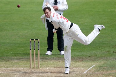 250525 - Glamorgan v Middlesex - Rothesay County Championship - Matthew Kuhnemann of Glamorgan bowls out Max Holden of Middlesex