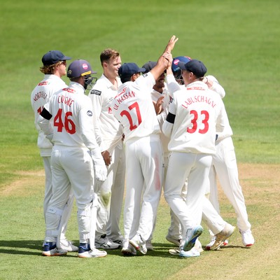 250525 - Glamorgan v Middlesex - Rothesay County Championship - Glamorgan celebrate after Asa Tribe catches the ball to dismiss Max Holden of Middlesex from the bowling of Matthew Kuhnemann