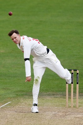 250525 - Glamorgan v Middlesex - Rothesay County Championship - Matthew Kuhnemann of Glamorgan bowls the ball to dismiss Sam Robson of Middlesex who was LBW