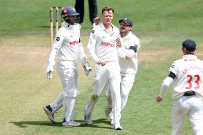 250525 - Glamorgan v Middlesex - Rothesay County Championship - Matthew Kuhnemann of Glamorgan celebrates with team mates after bowling out Sam Robson of Middlesex who was LBW