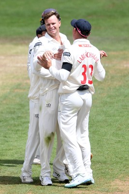 250525 - Glamorgan v Middlesex - Rothesay County Championship - Matthew Kuhnemann of Glamorgan celebrates with team mates after bowling out Sam Robson of Middlesex who was LBW