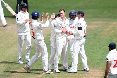 250525 - Glamorgan v Middlesex - Rothesay County Championship - Matthew Kuhnemann of Glamorgan celebrates with team mates after bowling out Sam Robson of Middlesex who was LBW