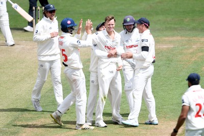 250525 - Glamorgan v Middlesex - Rothesay County Championship - Matthew Kuhnemann of Glamorgan celebrates with team mates after bowling out Sam Robson of Middlesex who was LBW