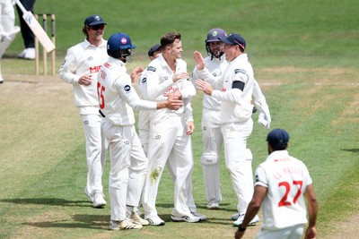 250525 - Glamorgan v Middlesex - Rothesay County Championship - Matthew Kuhnemann of Glamorgan celebrates with team mates after bowling out Sam Robson of Middlesex who was LBW
