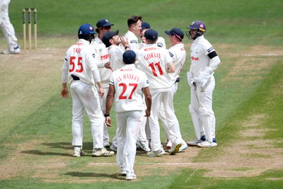 250525 - Glamorgan v Middlesex - Rothesay County Championship - Matthew Kuhnemann of Glamorgan celebrates with team mates after bowling out Sam Robson of Middlesex who was LBW