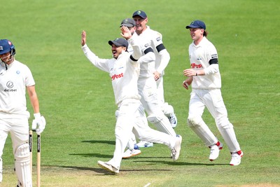 250525 - Glamorgan v Middlesex - Rothesay County Championship - Kiran Carlson of Glamorgan catches the ball to dismiss Luke Hollman of Middlesex