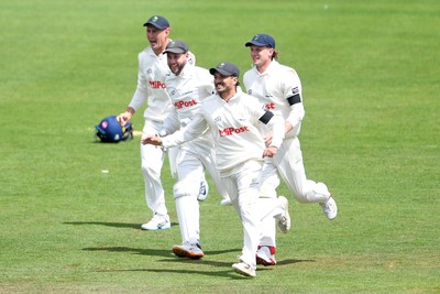 250525 - Glamorgan v Middlesex - Rothesay County Championship - Kiran Carlson of Glamorgan catches the ball to dismiss Luke Hollman of Middlesex