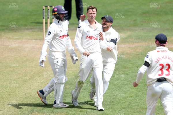 250525 - Glamorgan v Middlesex - Rothesay County Championship - Matthew Kuhnemann of Glamorgan celebrates with team mates after bowling out Sam Robson of Middlesex who was LBW