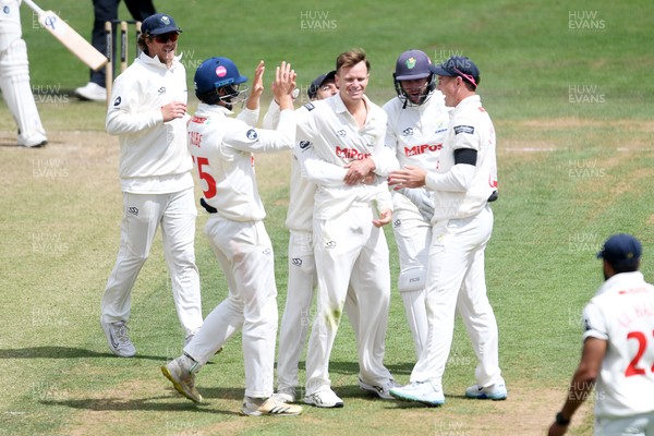 250525 - Glamorgan v Middlesex - Rothesay County Championship - Matthew Kuhnemann of Glamorgan celebrates with team mates after bowling out Sam Robson of Middlesex who was LBW