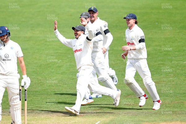 250525 - Glamorgan v Middlesex - Rothesay County Championship - Kiran Carlson of Glamorgan catches the ball to dismiss Luke Hollman of Middlesex