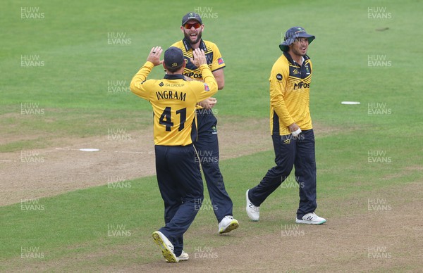 220823 - Glamorgan v Northamptonshire Steelbacks, Metro Bank One Day Cup - Jamie McIlroy of Glamorgan celebrates with Colin Ingram of Glamorgan after taking the wicket of Justin Broad of Northamptonshire