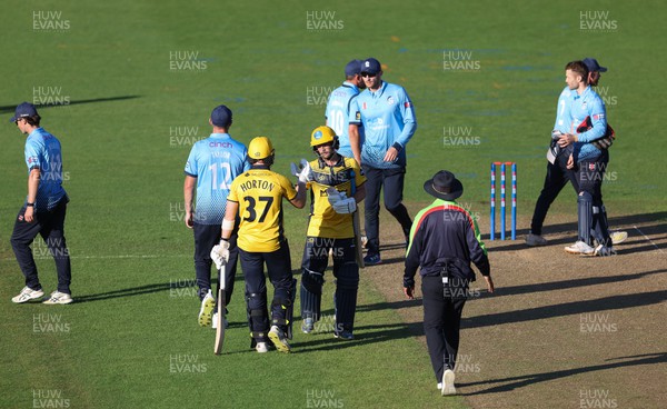 220823 - Glamorgan v Northamptonshire Steelbacks, Metro Bank One Day Cup - Alex Horton of Glamorgan and Billy Root of Glamorgan congratulate each other at the end of the match