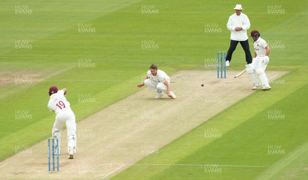110721 - Glamorgan v Northamptonshire, LV County Championship - Michael Hogan of Glamorgan attempts to stop the ball from a shot played by Emilio Gay of Northamptonshire