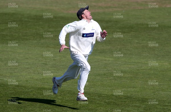130419 - Glamorgan Cricket v Northamptonshire - Specsavers County Championship Division Two - Michael Hogan of Glamorgan chases the ball in the air