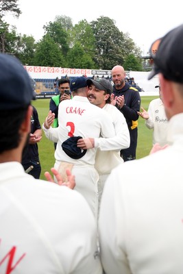 080526 - Glamorgan v Somerset - Rothesay County Championship -  Kiran Carlson of Glamorgan presents Mason Crane with a Glamorgan cap before the match