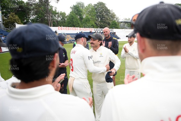 080526 - Glamorgan v Somerset - Rothesay County Championship -  Kiran Carlson of Glamorgan presents Mason Crane with a Glamorgan cap before the match