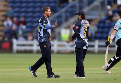 030625 - Glamorgan Cricket v Surrey - Vitality T20 Blast - Dan Douthwaite and Kiran Carlson of Glamorgan celebrate after Ollie Sykes is dismissed
