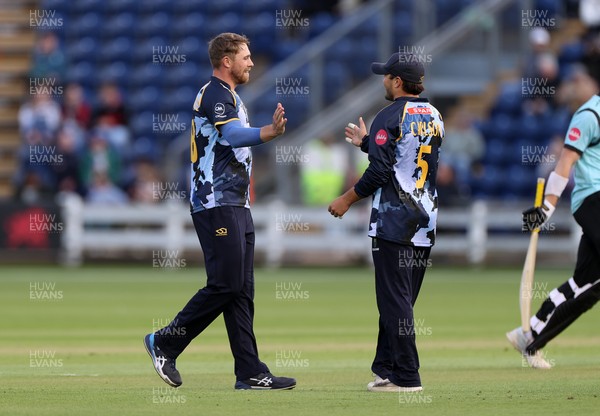 030625 - Glamorgan Cricket v Surrey - Vitality T20 Blast - Dan Douthwaite and Kiran Carlson of Glamorgan celebrate after Ollie Sykes is dismissed