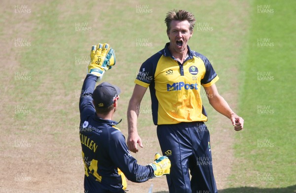 030821 - Glamorgan v Surrey, Royal London One Day Cup - Michael Hogan of Glamorgan celebrates after Mark Stoneman of Surrey is caught by Nick Selman of Glamorgan off his bowling with the first ball of the match