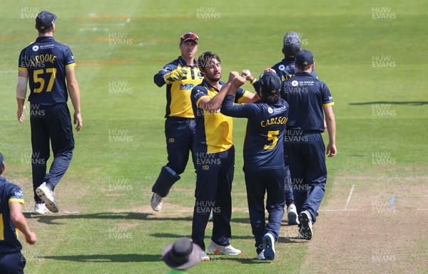 030821 - Glamorgan v Surrey, Royal London One Day Cup - Lukas Carey of Glamorgan celebrates with team mates after Ryan Patel of Surrey is caught by Nick Selman off his bowling