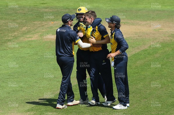 030821 - Glamorgan v Surrey, Royal London One Day Cup - Andy Gorvin of Glamorgan is congratulated after Rikki Clarke of Surrey is caught by Billy Root of Glamorgan off his bowling