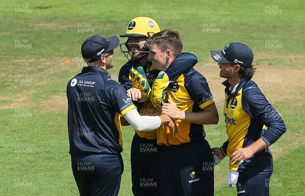 030821 - Glamorgan v Surrey, Royal London One Day Cup - Andy Gorvin of Glamorgan is congratulated after Rikki Clarke of Surrey is caught by Billy Root of Glamorgan off his bowling