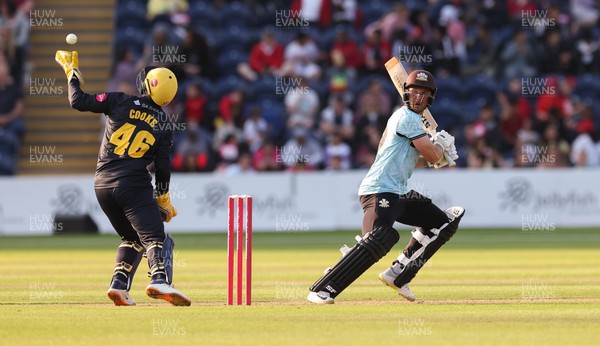 070623 - Glamorgan v Surrey, Vitality Blast T20 - Chris Cooke of Glamorgan juggles the ball as Laurie Evans of Surrey plays a shot