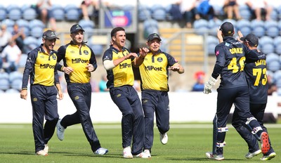 110819 - Glamorgan v Surrey, Vitality Blast - Ruaidhri Smith of Glamorgan celebrates taking the wicket of Aaron Finch of Surrey as he is caught by Chris Cooke of Glamorgan